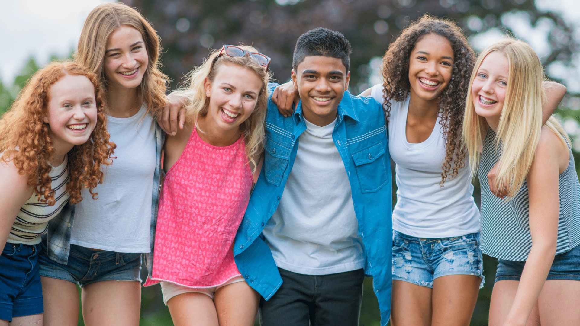 Group of smiling teen friends outdoors for orthodontic care at Bernhardt & Smith Orthodontics, Bishop Drive Office and 50th Street Office in West Des Moines, IA